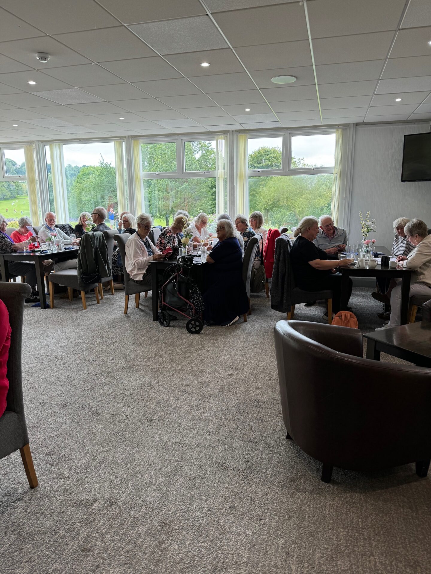people, table, plates of food, glasses,